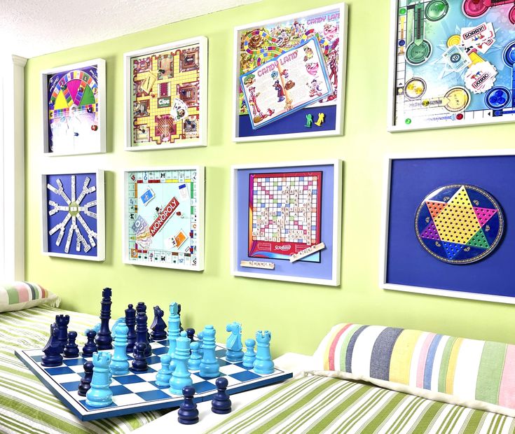 a chess board with pieces on it in front of pictures