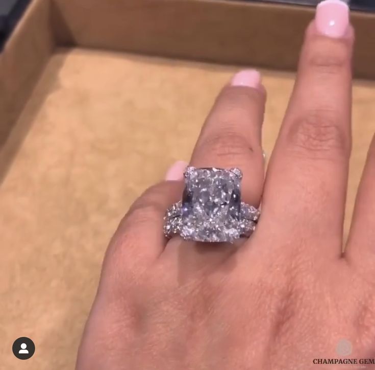 a woman's hand with a ring on it and a diamond in the middle