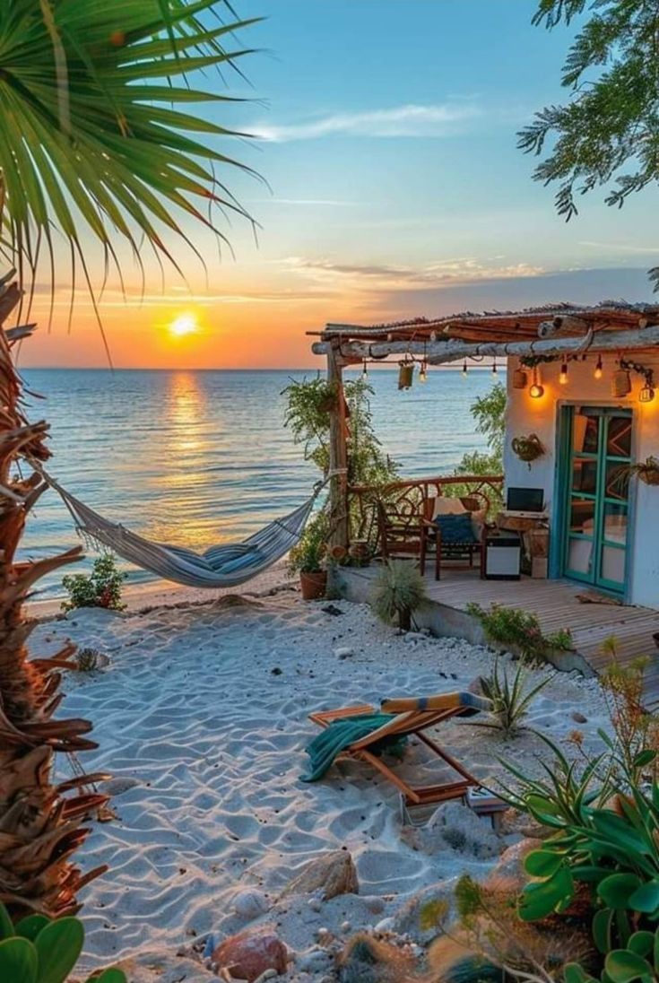 the sun is setting over the ocean with a hammock in the foreground