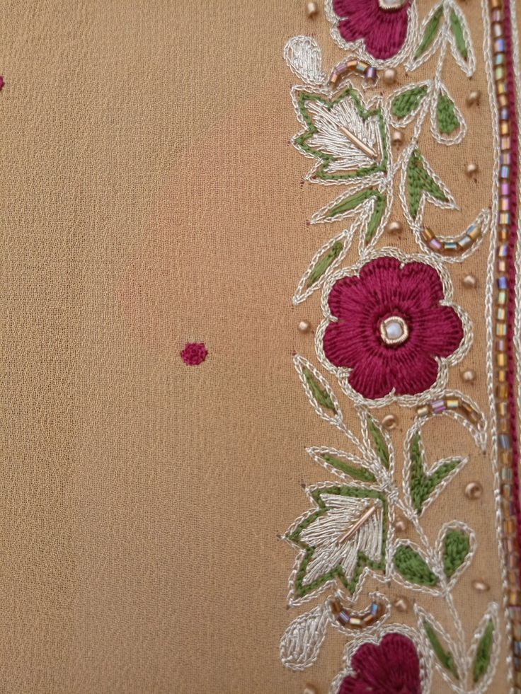 embroidered fabric with flowers and pearls on it