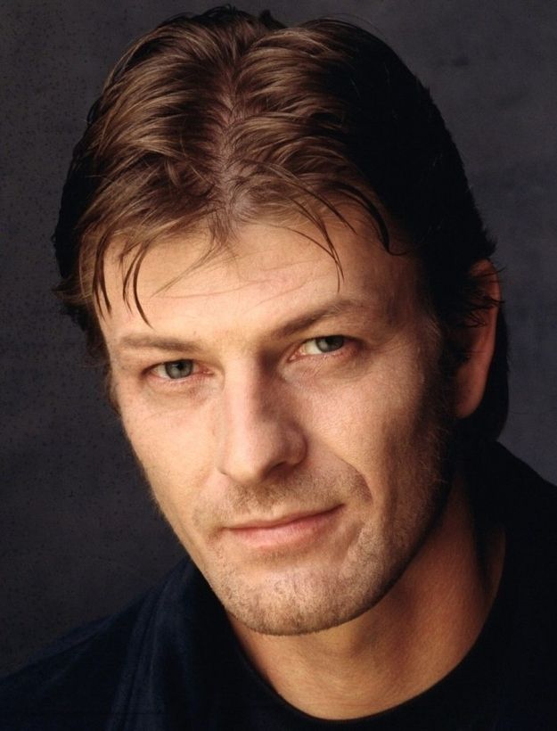 an autographed photograph of a man with brown hair and blue eyes, wearing a black shirt