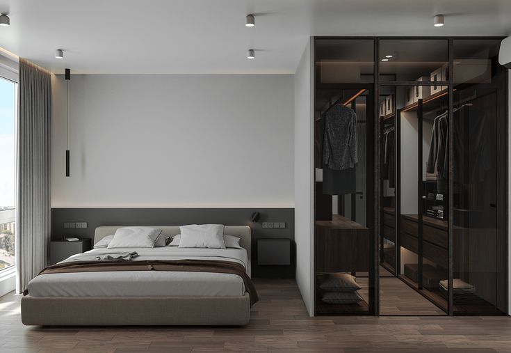 a bedroom with a bed and closets in it