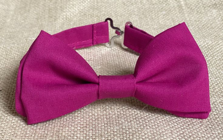 "Choose one of these style : - Bow tie ( adjustable strap) -Bow tie ( clip on- bow tie attaches to the collar) -Regular/Skinny Necktie -Pocket square Solid magenta pink Is a good combination for mix and matching groom, groomsmen and ring bearer. Please Specify Above** BOW TIE- clip-on style/or pre-tied style Baby: newborn- 1Y * Bow Tie: 3in wide Toddle: 2 years- 5 years Bow Tie: 3.5in wide Kids: 6years-12years * Bow Tie: 4in wide Teen/Adult- up to 6.5ft tall * Bow Tie: 5in Style of necktie : --- Classic Adjustable Bow Ties, Dapper Adjustable Tie With Satin Bow, Adjustable Satin Bow Tie In Dapper Style, Dapper Adjustable Satin Bow Tie, Dapper Adjustable Bow For Black Tie Events, Adjustable Dapper Bow For Black Tie Events, Adjustable Dapper Ties With Bow Tie Back, Formal Pink Adjustable Suit And Tie Accessories, Formal Adjustable Bow Tie