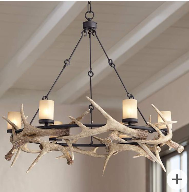 a chandelier with antlers hanging from it's sides and two lights on each side