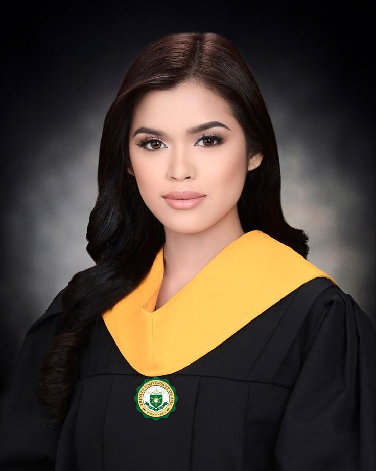 a woman in graduation gown posing for a photo