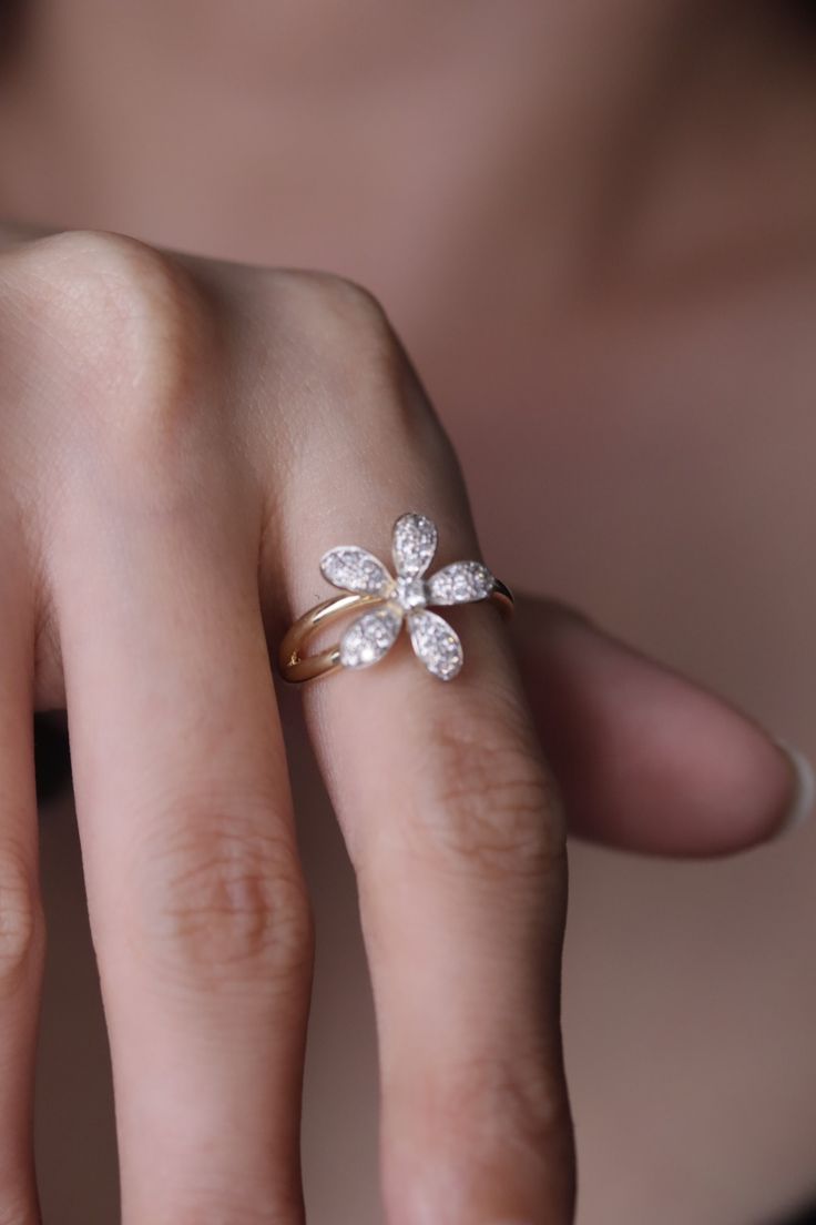 a woman's hand with a diamond ring on it