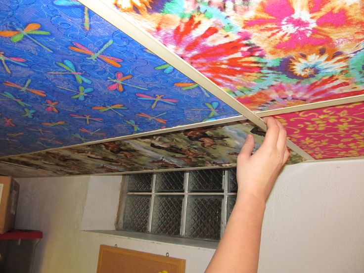 someone is painting the ceiling in their room with bright colors and designs on it's walls