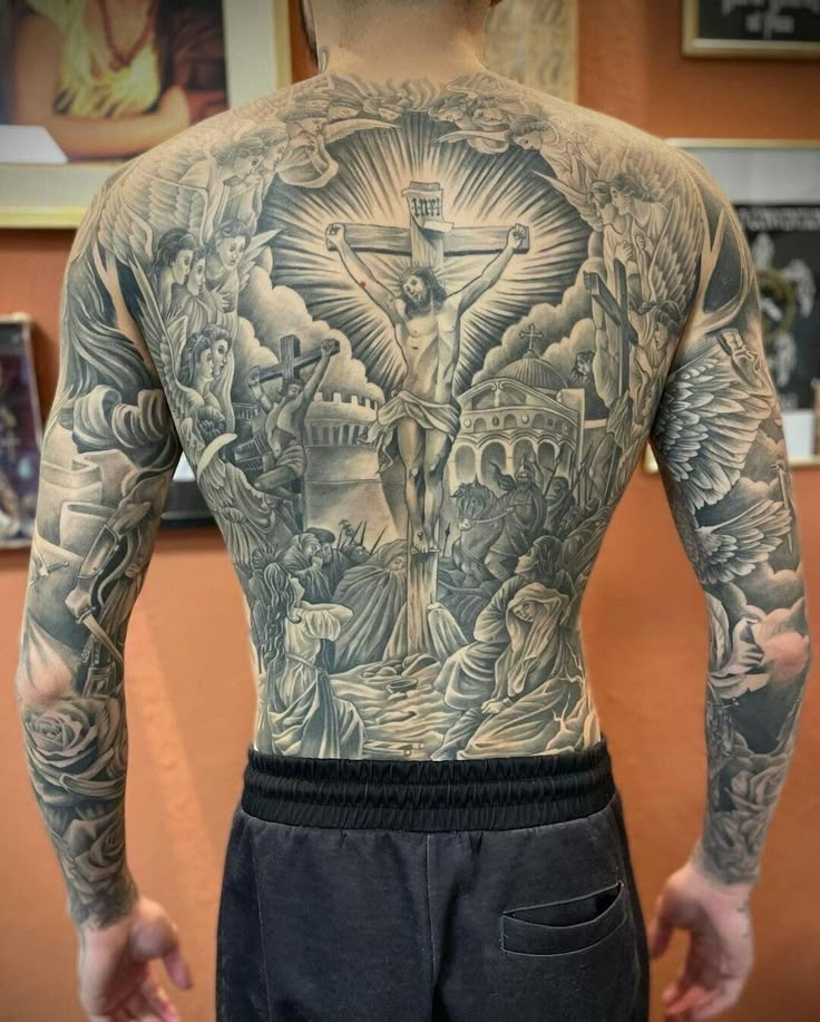 the back of a man with tattoos on his body