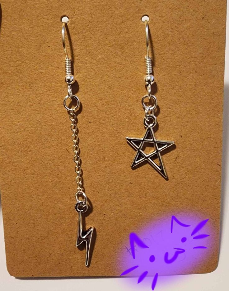 Made with stainless steel earring hooks and silver pendants Adjustable Star Earrings For Pierced Ears, Pierced Metal Star Earrings, Pierced Metal Star Jewelry, Pierced Star-shaped Metal Earrings, Pierced Star-shaped Metal Jewelry, Symbolic Silver Earrings With Ear Wire, Metal Star-shaped Jewelry, Symbolic Dangle Jewelry With Ear Wire, Gothic Silver Dangle Earrings