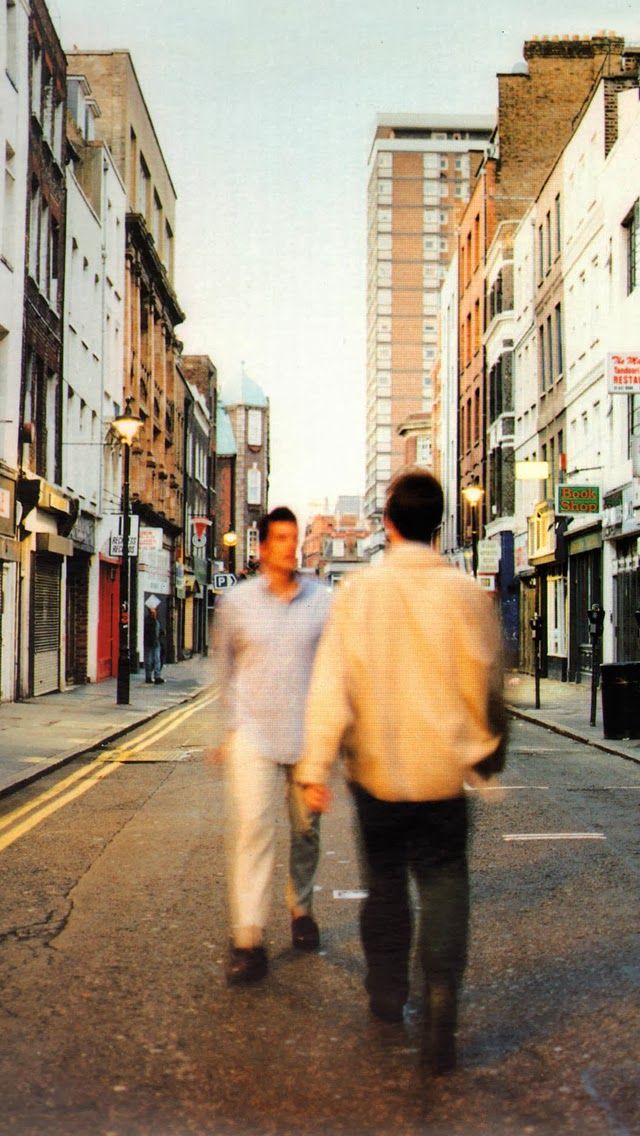 two men are walking down the street together