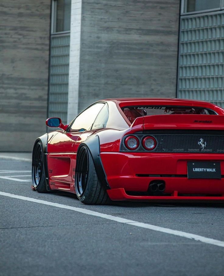 a red sports car parked in front of a building