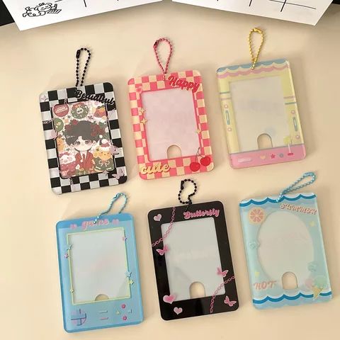 four different colored frames are hanging on the wall next to a note pad and keychain