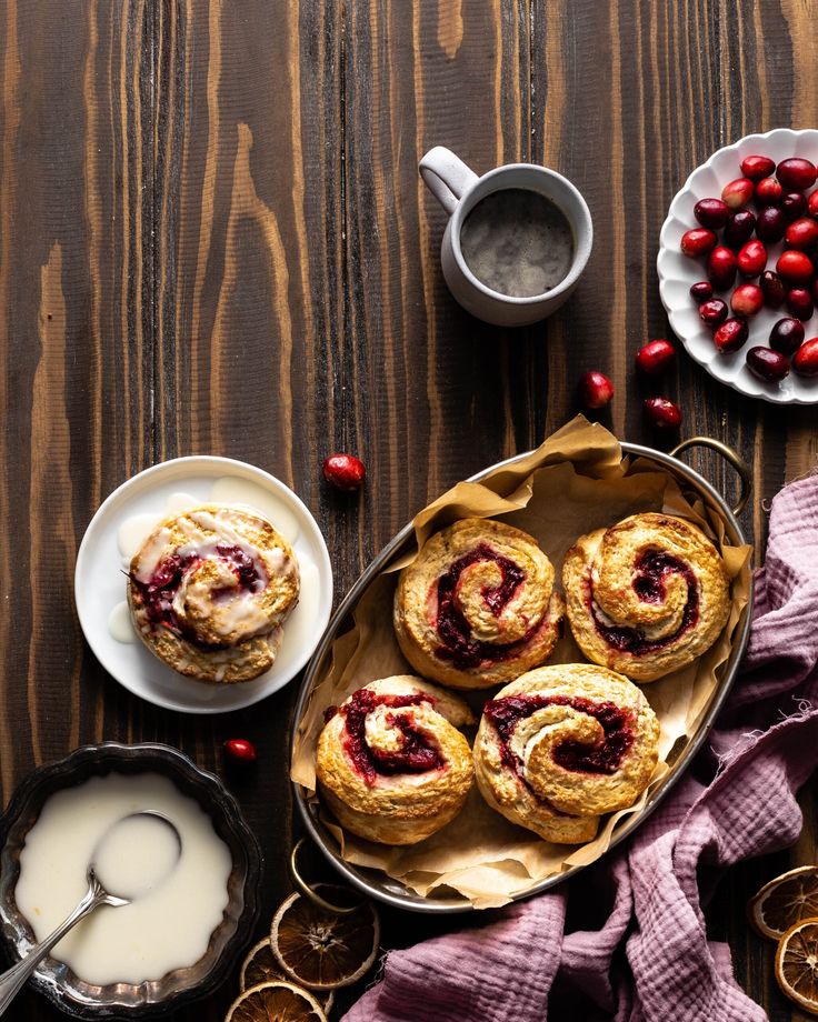 cranberry cinnamon rolls on a plate next to other desserts