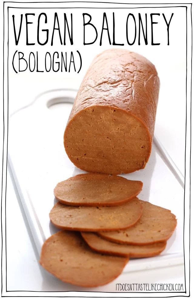 a loaf of bread sitting on top of a cutting board next to slices of bread