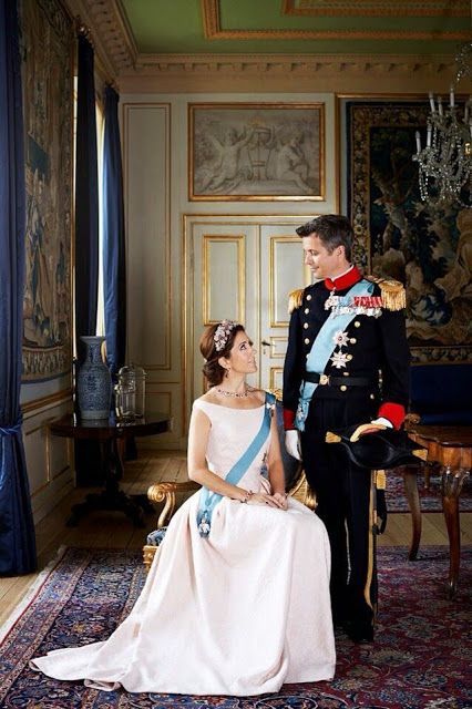 a man and woman in formal dress sitting next to each other