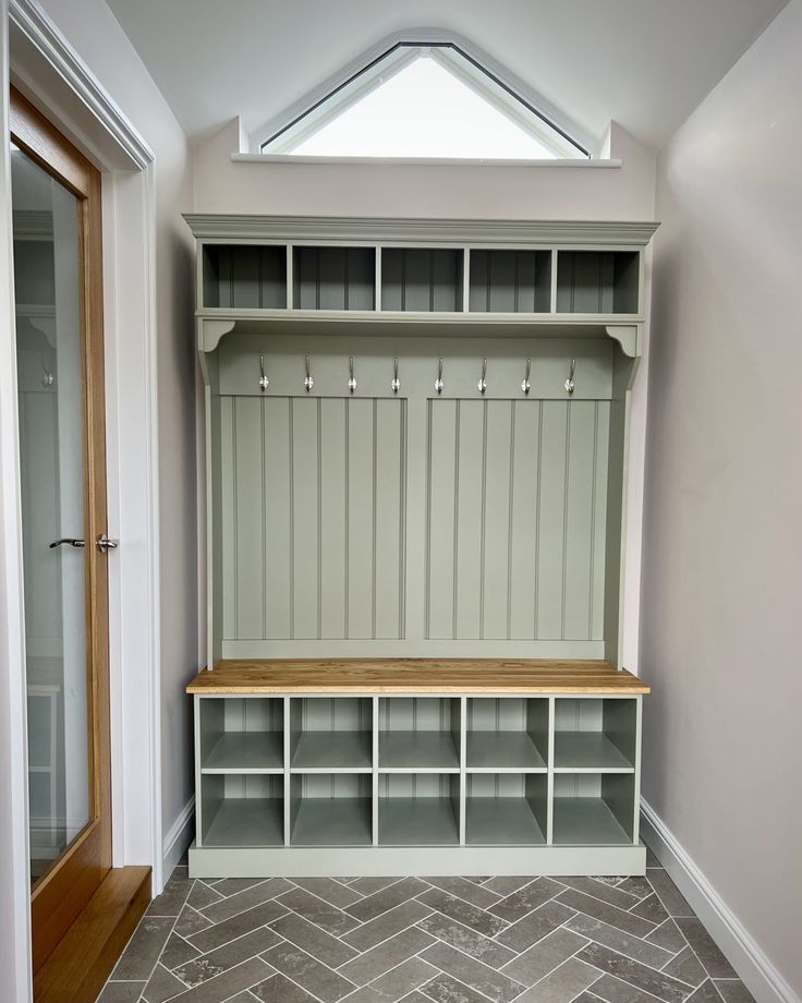 an empty room with a bench and shelves