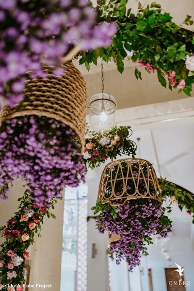 purple flowers hanging from the ceiling in a room