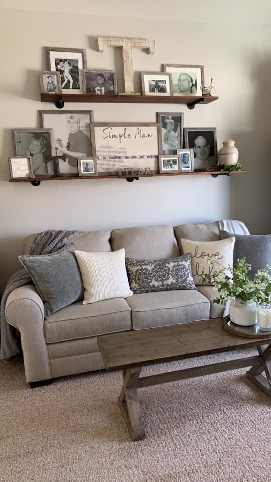 a living room filled with lots of furniture and pictures on the wall above it's coffee table