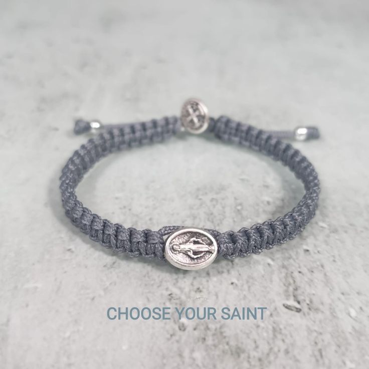 "This hand-woven bracelet features a 1cm silver tone medal charm in the center and a small St Benedict medal on top of the clasp. Design your own bracelet and we will make it for you. Choose Saint Medal and Cord color for your bracelet and it will be made just for you. You can choose from different medals of saints and cord colors. (SEE PHOTOS 4,5,6) Hand woven in Medjugorje. Medals made in Italy. This unique bracelet comes on string with a sliding slipknot for an easy fit. 9.5 \"(24cm) when ful Adjustable Miraculous Medal For Gift, Adjustable Hypoallergenic Silver Rosary Bracelet, Adjustable Rosary Bracelet With Miraculous Medal For First Communion, Adjustable Spiritual Bracelets With Miraculous Medal, Silver Spiritual Rosary Bracelet For Blessing, Handmade Adjustable Rosary Bracelet For First Communion, Handmade Silver Bracelets For First Communion, Adjustable Silver Rosary Bracelet With Miraculous Medal, Adjustable Silver Rosary Bracelet With Charms