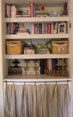 a bookshelf filled with lots of books next to a window