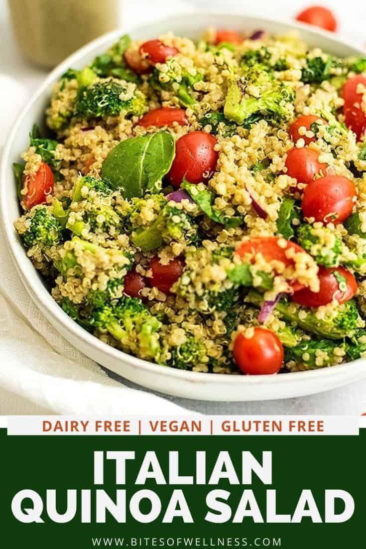 a white bowl filled with quinoa salad next to a jar of dressing