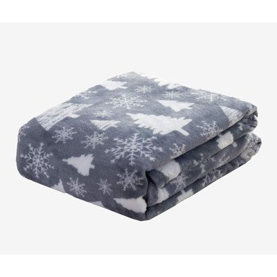 a blanket that has snowflakes on it and is folded up in front of the camera