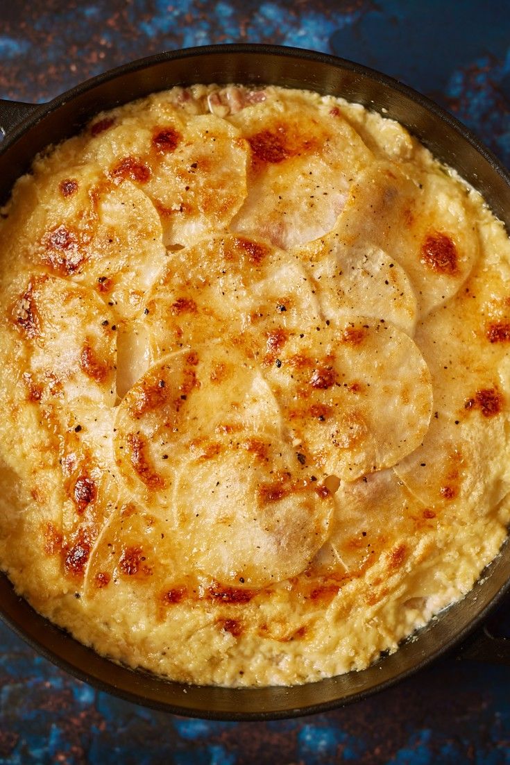 an omelet in a cast iron skillet on a blue surface