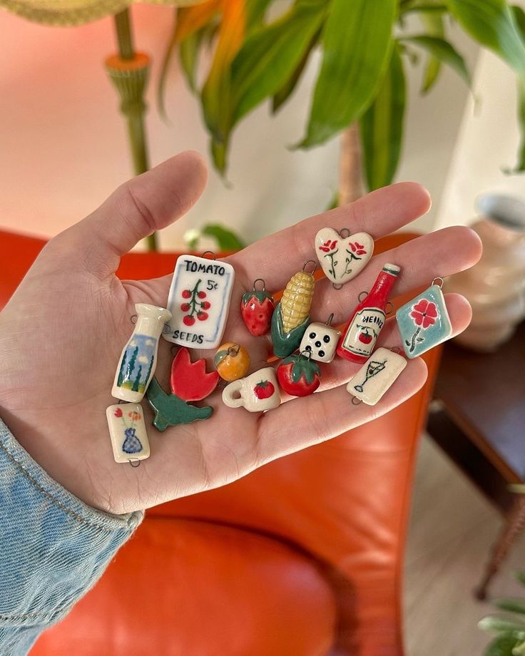 a person holding several small magnets in their hand