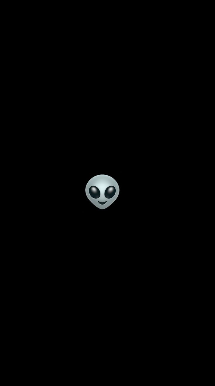 an alien face is shown in the dark