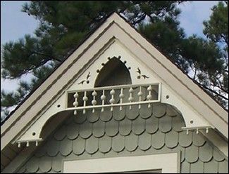 the roof of a house with an arched window