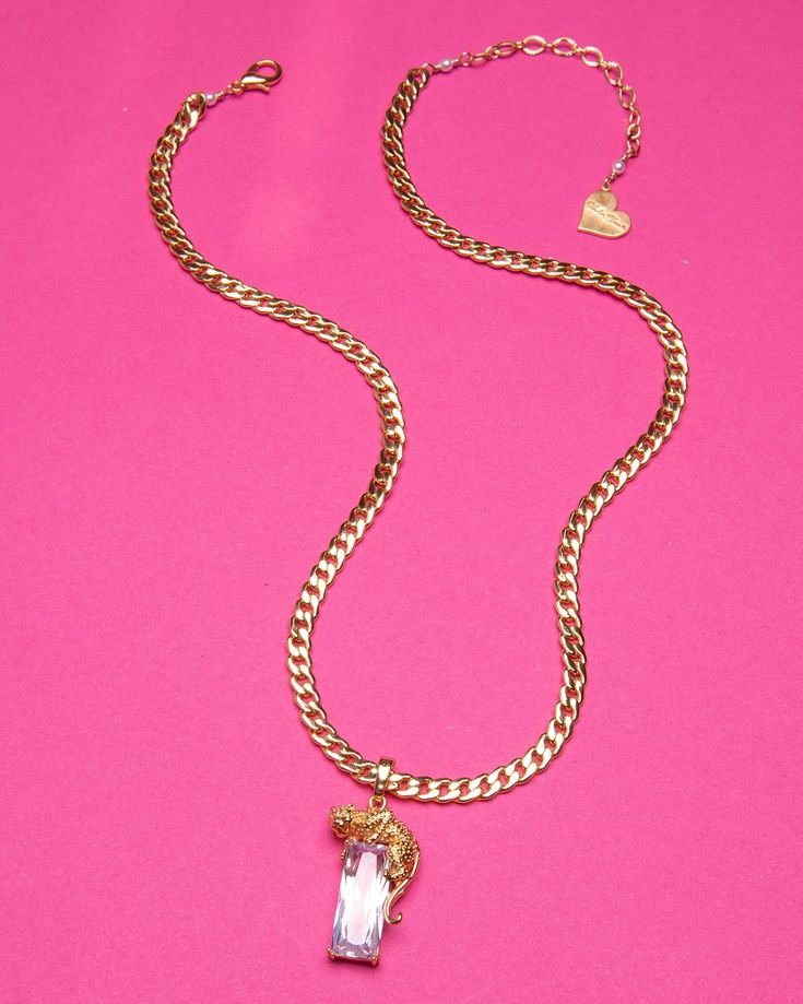 This luxurious Jaguar Necklace features an exquisite jaguar design with a glittering rectangle crystal accent, perfect for adding a hint of glamour and extravagance to every outfit. It is the quintessential piece of jewelry for adding an elegant, sophisticated touch to any ensemble. *14"-16" Adjustable Necklace (Sizes Available) *18K Gold Plated *Lead and Nickel Free, Hypoallergenic *Handmade in Los Angeles Chic Crystal Jewelry With Jewels, Elegant Metal Chain Necklace With Square Pendant, Chic Bling Jewelry For Gifts, Elegant Metal Jewelry With Rectangular Pendant, Chic Gold Necklaces With Rhinestones, Chic Formal Necklace With Rhinestones, Chic Gold Crystal Jewelry, Chic Gold Rhinestone Necklace For Gift, Trendy Formal Jewelry With Rhinestones