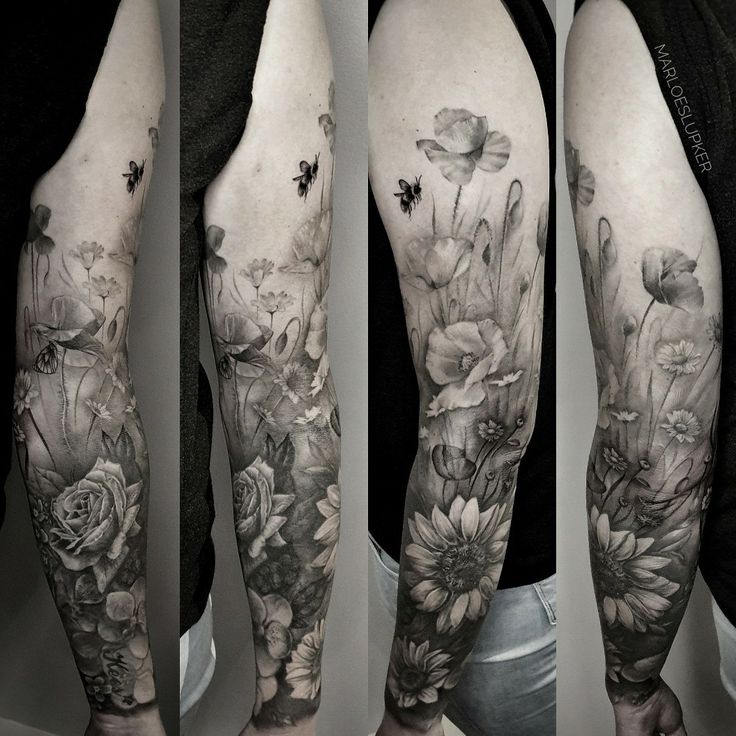 the arm is covered with flowers and butterflies