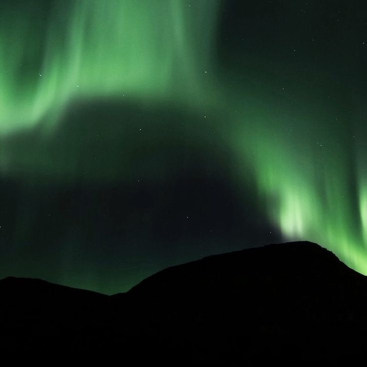 the northern lights shine brightly in the night sky