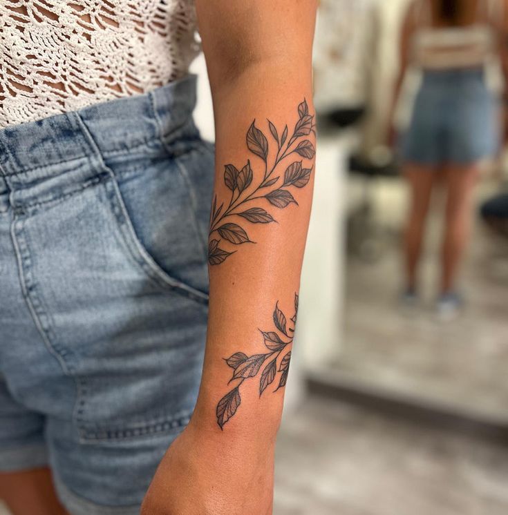 a woman with a flower tattoo on her arm