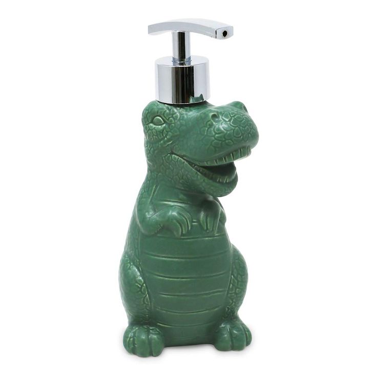 a soap dispenser shaped like a crocodile with a toothbrush in its mouth