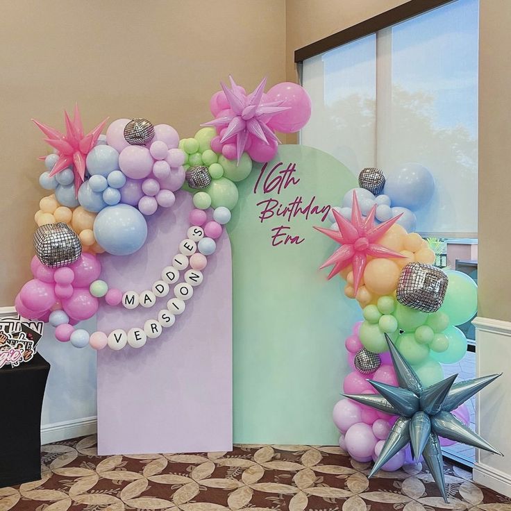 balloons and decorations decorate the entrance to a birthday party