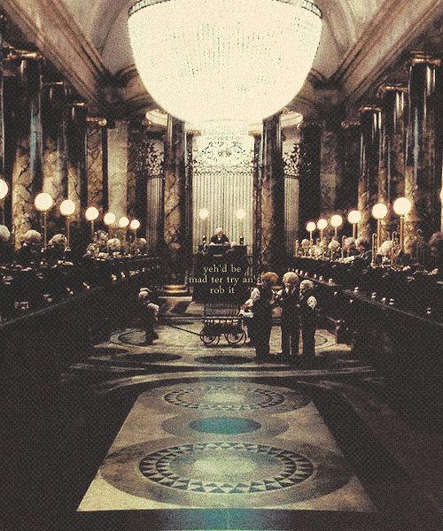 an ornately decorated hall with chandeliers and people standing in the doorways