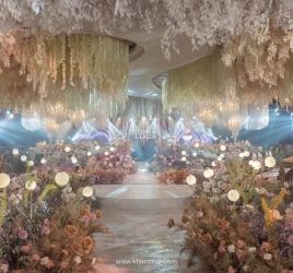 an elaborately decorated hall with chandeliers and flowers