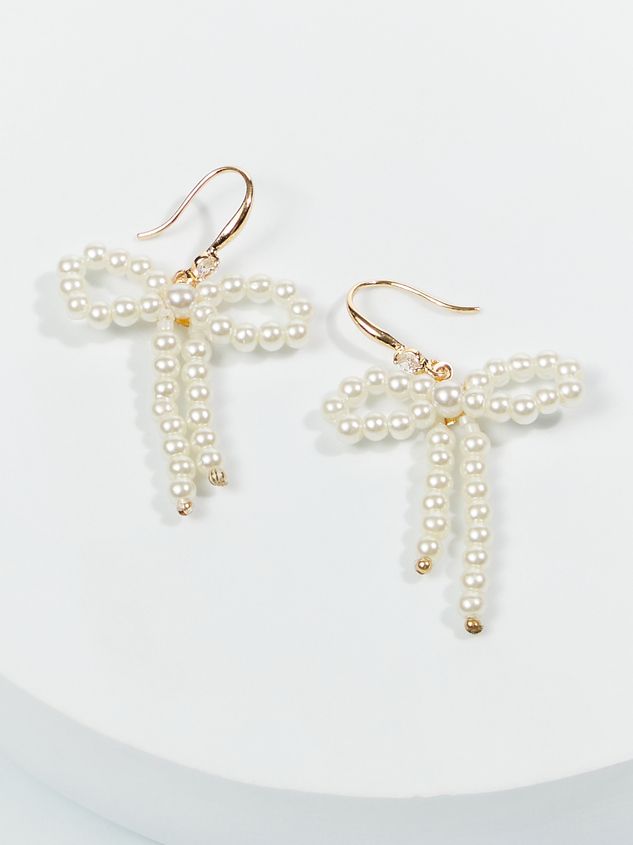 pair of gold tone earrings with white pearls in the shape of a dragon and cross