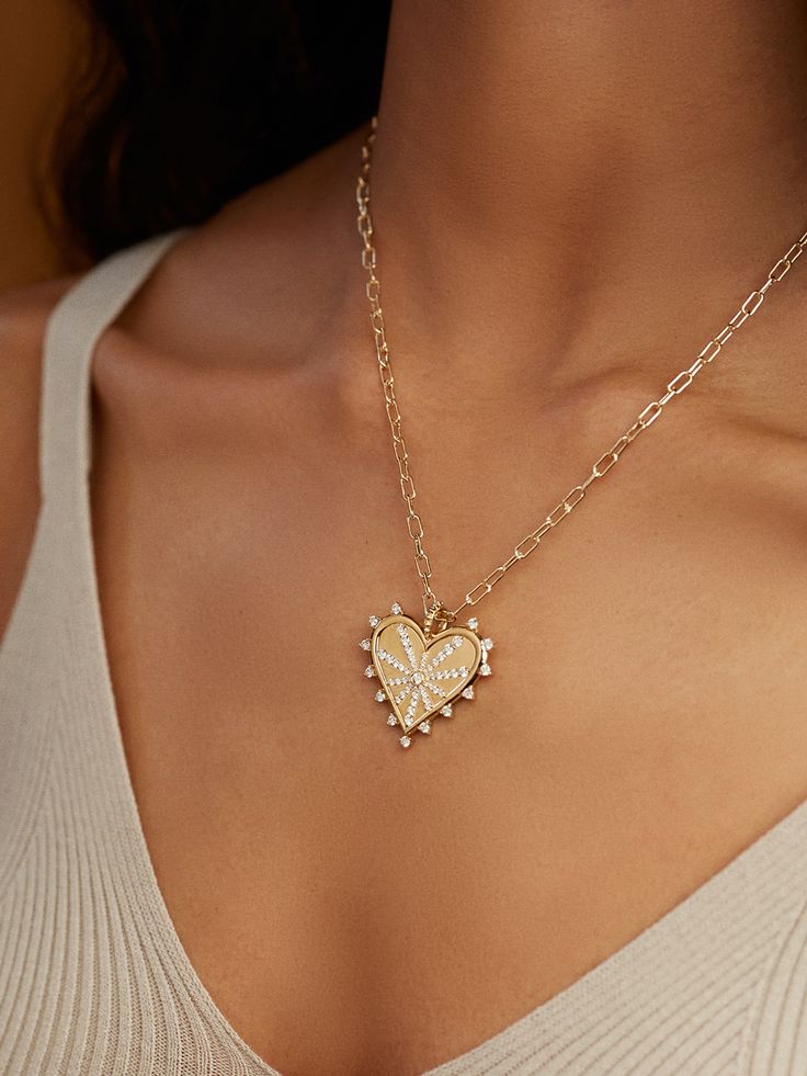 This romantic yet edgy Spiked Pavé Heart Charm Necklace is one of our all-time favorites! Also known as the Carrie Bradshaw Necklace, this piece is hand-cast from 14-karat gold and strung with a starburst diamond heart pendant, centered by a dazz... Gold Plated Heart Pendant Jewelry, Gold Plated Heart Beads Pendant Jewelry, Heirloom Heart Shaped Charm Necklace, Heirloom Heart Pendant Necklace With Charms, Heirloom Heart-shaped Jewelry With Heart Charm, Valentine's Day Gold Jewelry With Star Charm, Valentine's Day Gold Star Charm Jewelry, Gold Jewelry With Star Charm For Valentine's Day, Valentine's Day Heart Pendant Jewelry With Star Charm