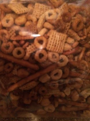 a bag filled with lots of different types of cereals and pretzels in it