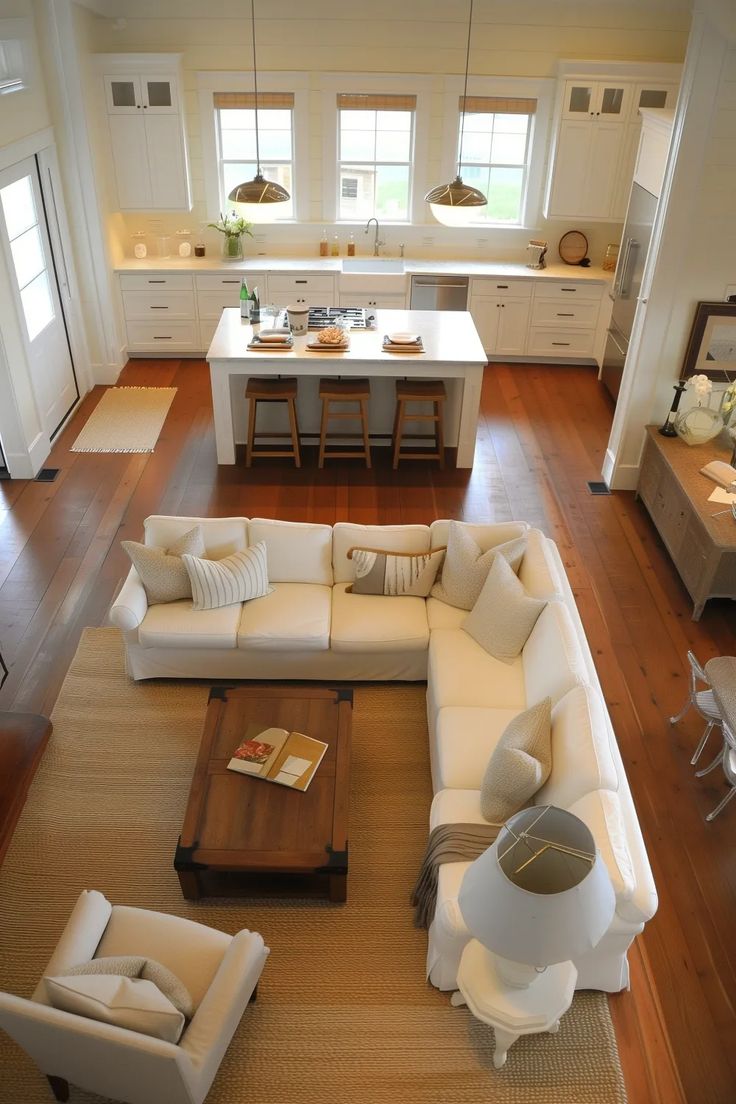 an aerial view of a living room and kitchen area in a house with hardwood floors