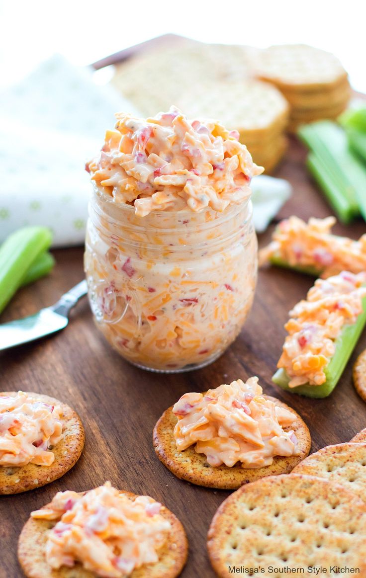 crackers and dip in a jar on a table