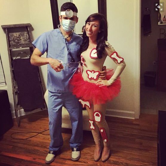 a man standing next to a woman in a red tutu and face mask on