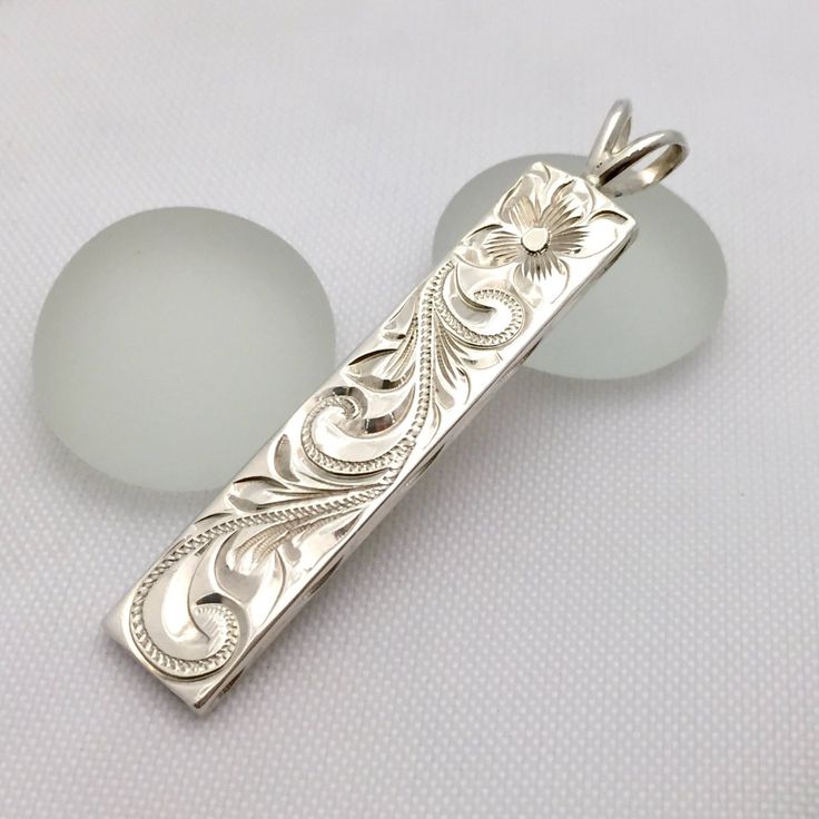 Custom order and Hand made in the Aloha StateHand engraved with Old English design - Hawaiian Maile, Plumeria, and Ocean wave.Sterling Silver1.25" length2mm thickGreat gift for anniversary, wedding or any special occasion.FREE SHIPPING in the USU.S order will be shipped FREE with USPS First Class Mail with tracking. Upgraded shipping - Priority & Express shippings are also available upon checkout International orders will be shipped with USPS International First Class Mail with tracking. Upg Hand Engraved Jewelry, Hawaiian Heirloom Jewelry, Face Jewellery, Gift For Anniversary, Hawaiian Jewelry, English Design, Heirlooms Jewelry, Cabochon Jewelry, Metal Engraving