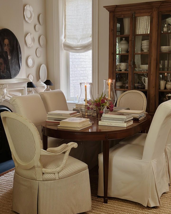 a dining room table with chairs and books on it