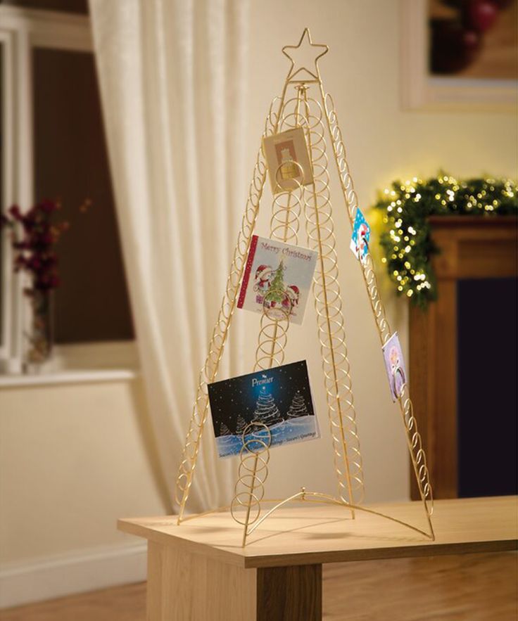 a wooden table topped with cards on top of a wooden stand next to a window