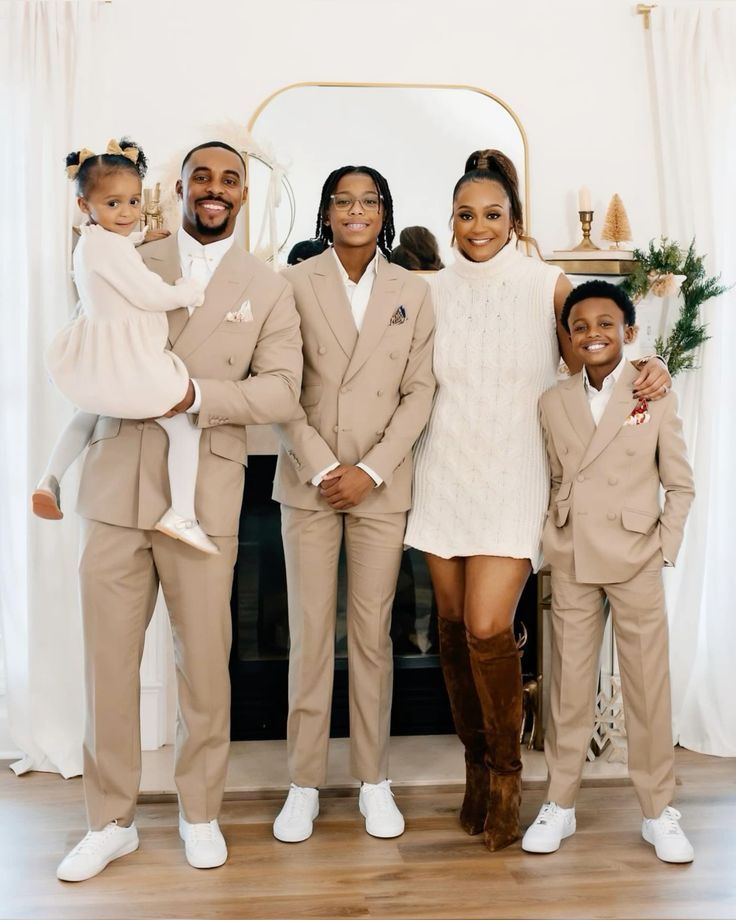 a family posing for a photo in front of a fireplace