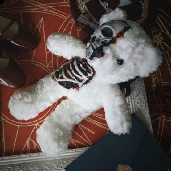 a white teddy bear wearing a skeleton costume