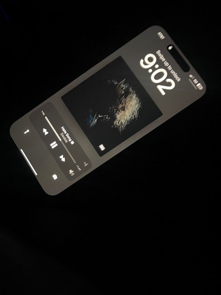 a cell phone with an ad on it in the dark